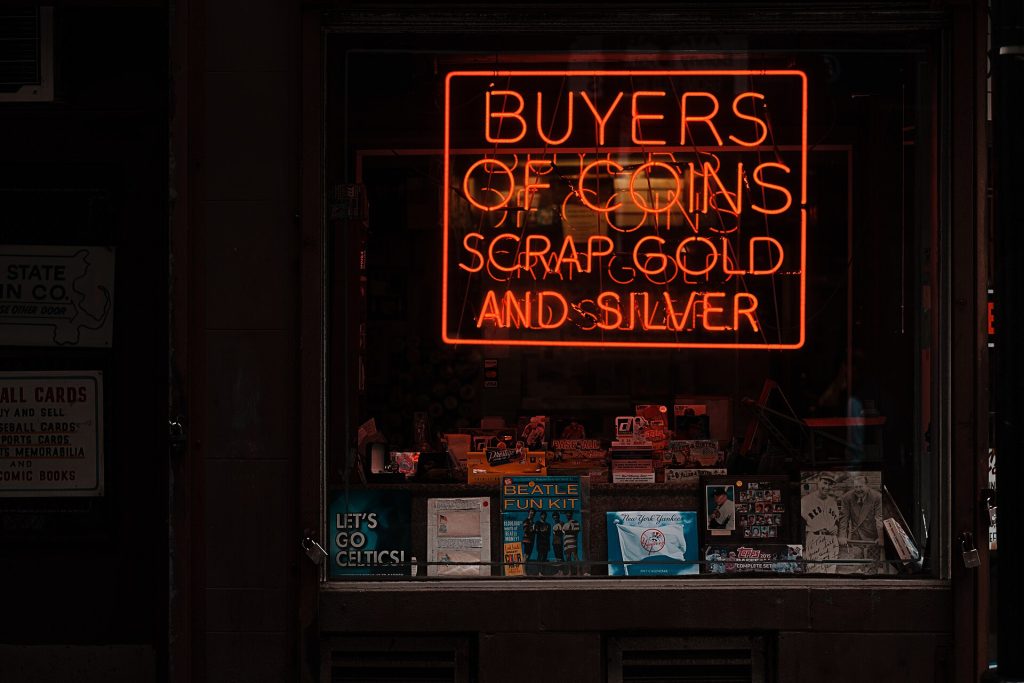 Red neon coin sign (Unsplash)
